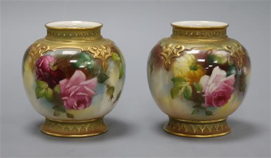 A pair of Royal Worcester vases, decorated with roses H.9.5cm